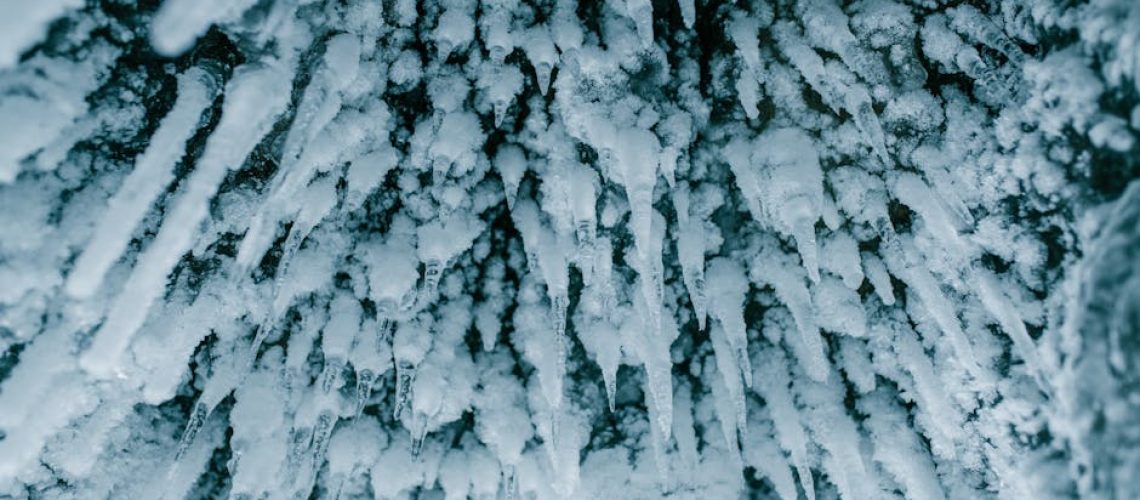 Detailed view of icicles forming in a cold winter environment, showcasing nature's frozen beauty.